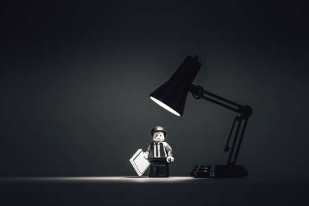 Exhausted man working late in office. Illustrative editorial. January 14, 2022