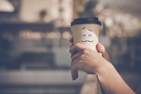 Woman holding take away coffee cup mascotの写真素材