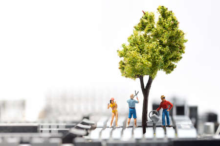 Group of people growing a tree on circuit board. Green environment conceptの写真素材