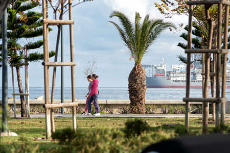 Limassol, Cyprus - February 22, 2019: People Walking at Molos Seaside Park with Offshore Drilling Rig on backgroundのeditorial素材