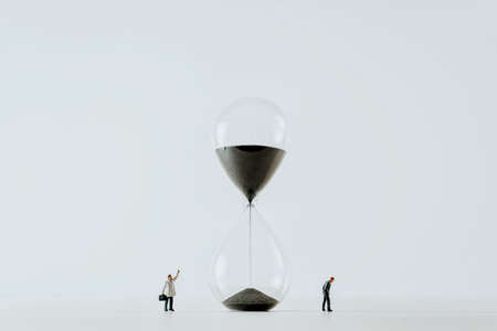 Business people looking at Hourglass. Time management conceptの写真素材