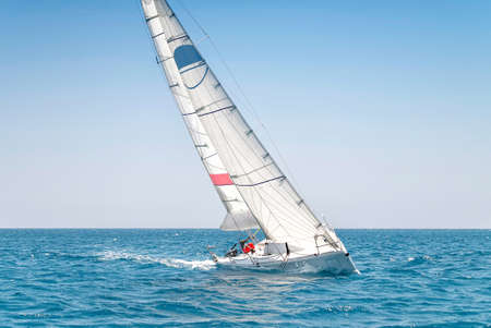 Sailing keelboat yacht with white sails