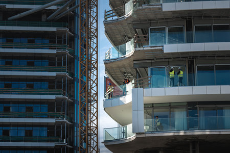 Limassol, Cyprus - February 10, 2022: Workers at the high-rise building construction siteのeditorial素材