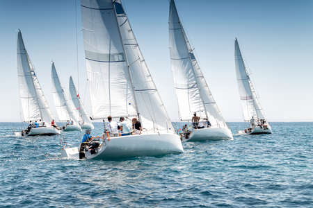Sailing boats on the start line of regatta