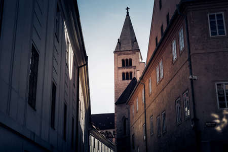 Narrow street in Prague castle with tower of St. Georges Basilica on background. Prague, Czech...