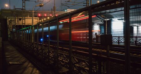 lights of the past train behind the trellis at night