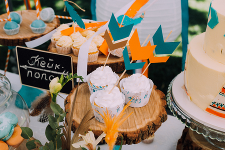 Holiday design for children's holiday in boho style, a magical children's birthday party. Design frame with bird feathers in turquoise, beautiful Indian hut with beautiful cushions and printsの写真素材
