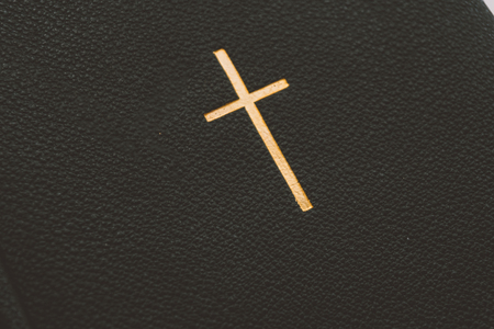 Catholic book with a gold cross, a Catholic book with gold pages and symbols. Catholic faith in...