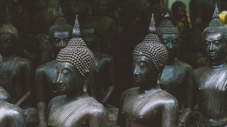 old Buddha statues on the local market close-up. Buddha as a symbol of Buddhism in Thailand and Asia. Portrait of a buddha in statue format on the local marketの写真素材