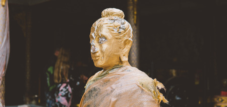 Closeup of antique wood statue of Buddha
