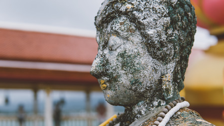 Closeup of antique wood statue of Buddhaの写真素材