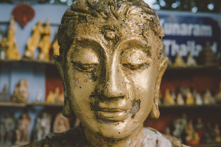 Buddha statue as amulets of Buddhism religion close-up. Old Buddha faceの写真素材