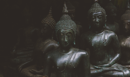 Big Buddha statues in the local Thai market. Antique Buddha statues close-up