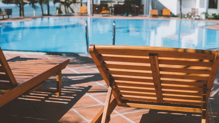 sun loungers near the hotel swimming pool. Tropical vacation in Asia, millennial conceptの写真素材