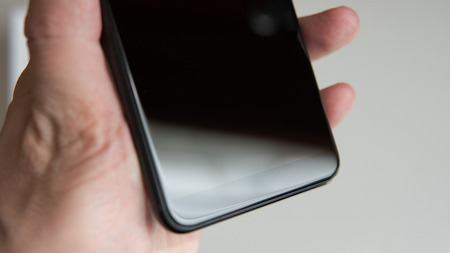 black modern smartphone in mans  hand