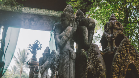 Balinese traditional stone statues in the form of demons and gods close-up.の写真素材