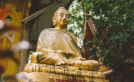a statue of a golden buddha close-up. Bodhi condition of holy god