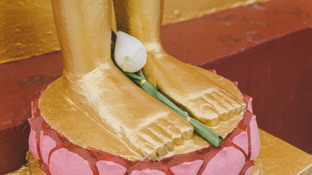 a statue of a golden buddha close-up. Bodhi condition of holy godの写真素材