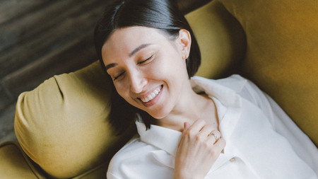 smiling girl in white dress on the white background.  Film Grain style,  Cinematic Lookの写真素材