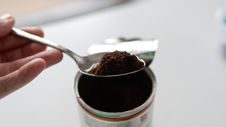 ground coffee in a tablespoon. Portion of coffee for cooking.の写真素材