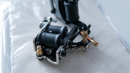 Accessories for tattooing on the skin. Tattoo machines close-upの写真素材