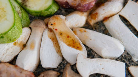 cooking steppe oyster mushrooms, useful eringi mushrooms. Grilling mushrooms on stoneの写真素材