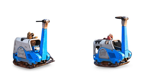 Two models of reversible vibratory plates isolated on a white background. Each model features a distinct design and color scheme, showcasing construction equipment.の写真素材