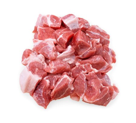 An overhead close-up of a pile of raw, diced pork shoulder chunks, showing marbling and a white fat cap, isolated on white. High quality photoの写真素材