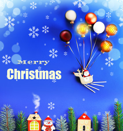 Merry Christmas greeting with Santa on a reindeer float lifted by baubles over wooden houses and fir branches. High quality photoの写真素材