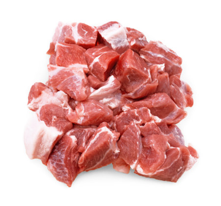 An overhead close-up of a pile of raw, diced pork shoulder chunks, showing marbling and a white fat cap, isolated on white. High quality photoの写真素材