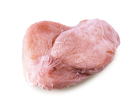 A large, frosty piece of frozen light pink chicken breast or turkey meat isolated on a pure white background with a subtle shadow. High quality photoの写真素材