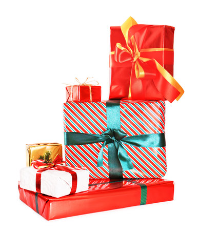 A colorful stack of Christmas presents wrapped in red, striped, and gold paper with festive ribbons, isolated on white. High quality photoの写真素材
