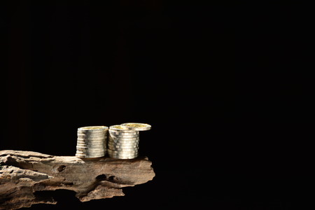 Coins on the old wood and black background.の写真素材