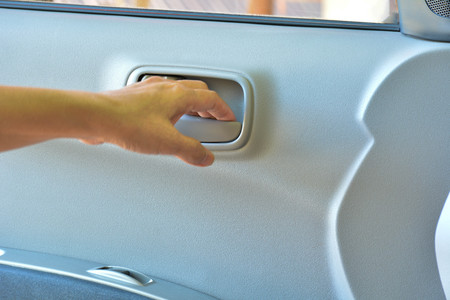 Hand of human go to opening the white door of carの写真素材