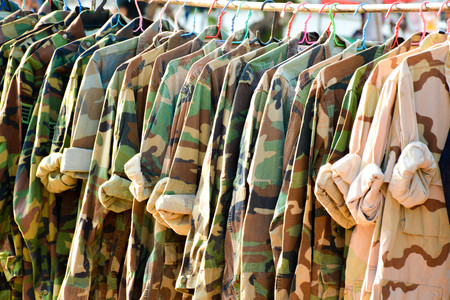 Many military shirt hang on a wood clotheslineの写真素材