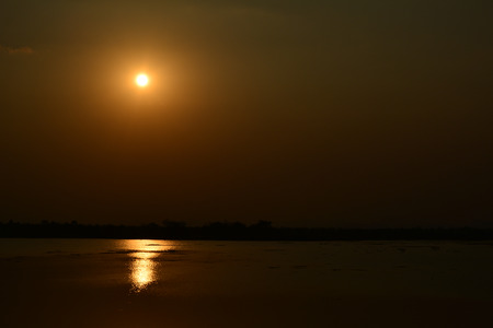Beautiful sunset landscape and orange sky, sun golden reflection backgroundの写真素材