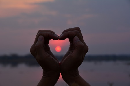 hand shape heart symbol silhouette style under the skyの写真素材
