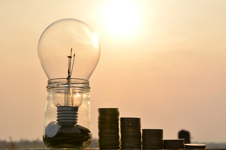 light bulbs and stack coins idea concept and silhouette style on road and under the sky
の写真素材