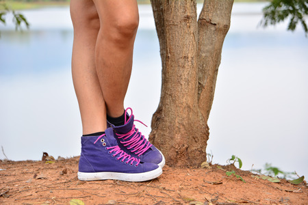 leg of person standing beside tree