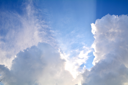 white fluffy clouds in the blue skyの写真素材