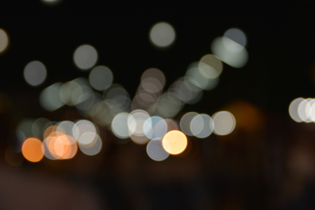 glitter bokeh lights bokeh defocused with dark background.の写真素材