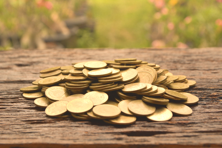 pile of gold coin on the wooden background  financial and saving concept.の写真素材