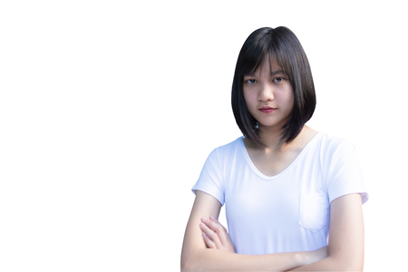 Young woman standing with arms crossed over isolated on white backgroundの写真素材