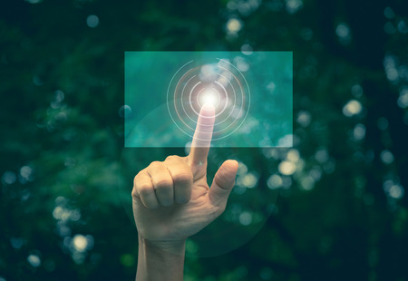 Hand click on virtual touchscreen button. Hand pressing modern buttons. Man hands pressing virtual screens technology concept.の写真素材