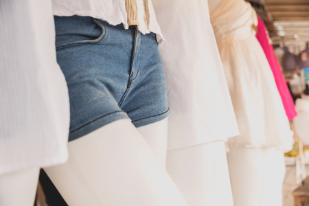 collection of jeans shorts. Modern torn blue jeans shorts on mannequin model.の写真素材