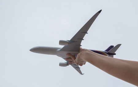 Kid playing with toy airplane. Kids playing with toy airplane at the day time. Kid having fun outdoors.の写真素材
