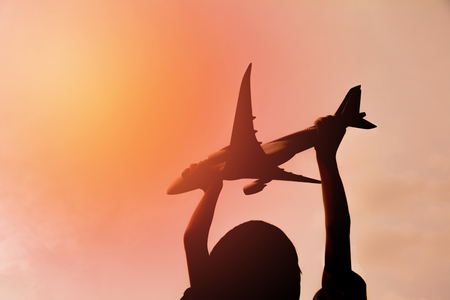 Kid playing with toy airplane. Kids playing with toy airplane at the day time. Kid having fun outdoors.の写真素材