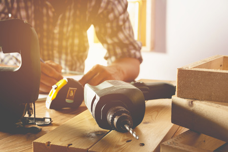Architect engineer working concept with blueprint, yellow helmet and tools on table.の写真素材