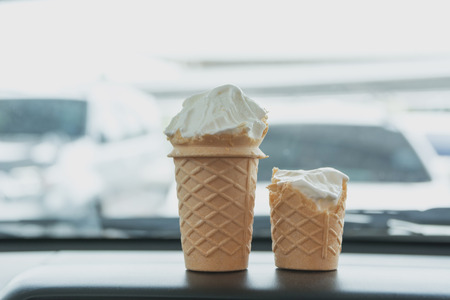 Soft white milk cream ice cream cone in the cone in the car in summer day.の写真素材