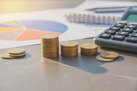 Stock financial indices with stack coin and calculator. Financial stock market in accounting market economy analysis.の写真素材